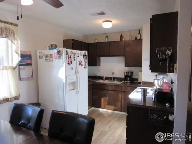 a kitchen with a refrigerator and a sink