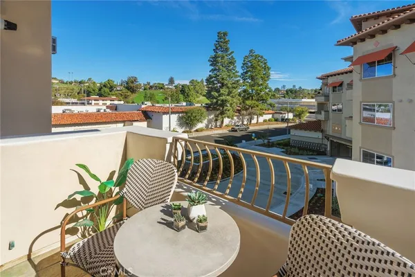 a balcony with table and chairs