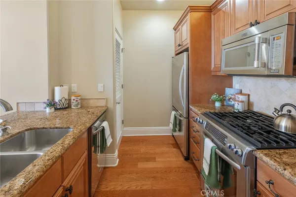 a spacious bathroom with a granite countertop sink and a mirror
