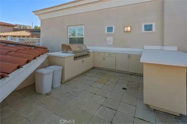 a view of a patio with plants and chairs
