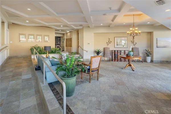 a living room with dining table and a potted plant
