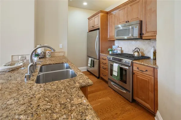 a kitchen with a table chairs sink and stove
