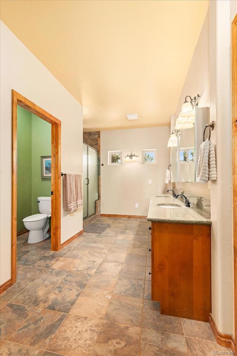 990 Hamilton Creek Road Coaldale, CO 81222 - Photo 19 of 49 a view of a bathroom with a sink and mirror