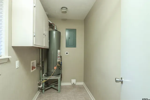 an empty room with a windows and chandelier fan
