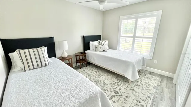 a large bed sitting in a bedroom next to a window