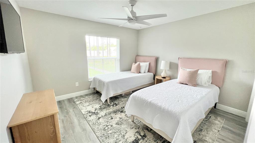 6944 Southwest 179th Ave Road Dunnellon, FL 34432 - Photo 16 of 19 a bedroom with two beds and a chandelier