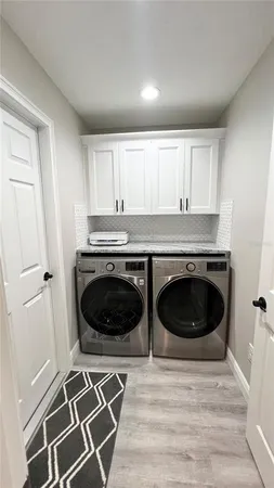 a kitchen with a stove and white cabinets