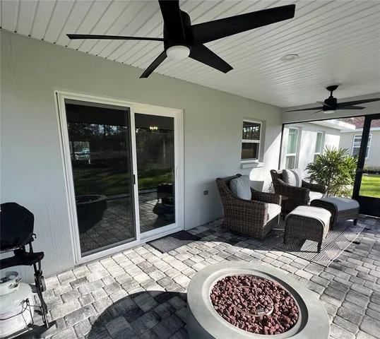 a bedroom with furniture and a large window