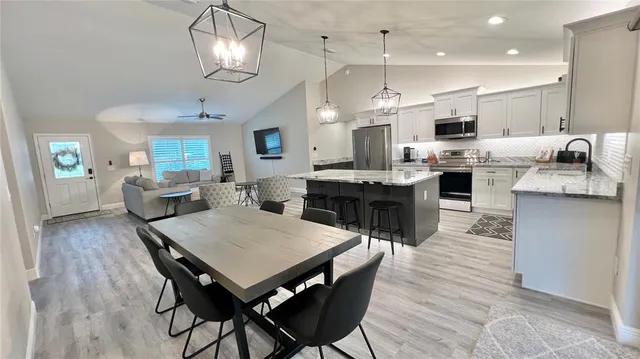 a large kitchen with a table and chairs