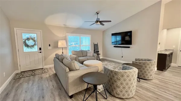 a living room with furniture and a flat screen tv