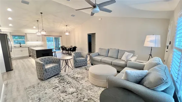 a living room with furniture and a chandelier