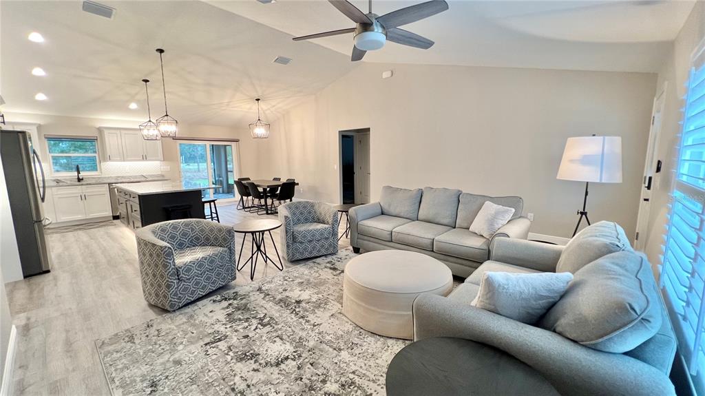 6944 Southwest 179th Ave Road Dunnellon, FL 34432 - Photo 10 of 19 a living room with furniture and a chandelier
