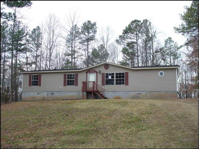2912 Wallace Road Gainesville, GA 30507 - Photo 1 of 1 a house that is sitting in the grass with large trees