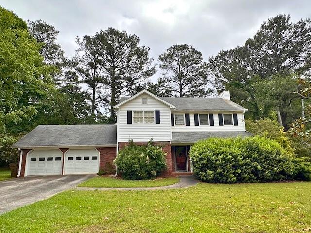 3310 Rangers Gate Marietta, GA 30062 - Photo 1 of 1 a front view of a house with a garden and yard