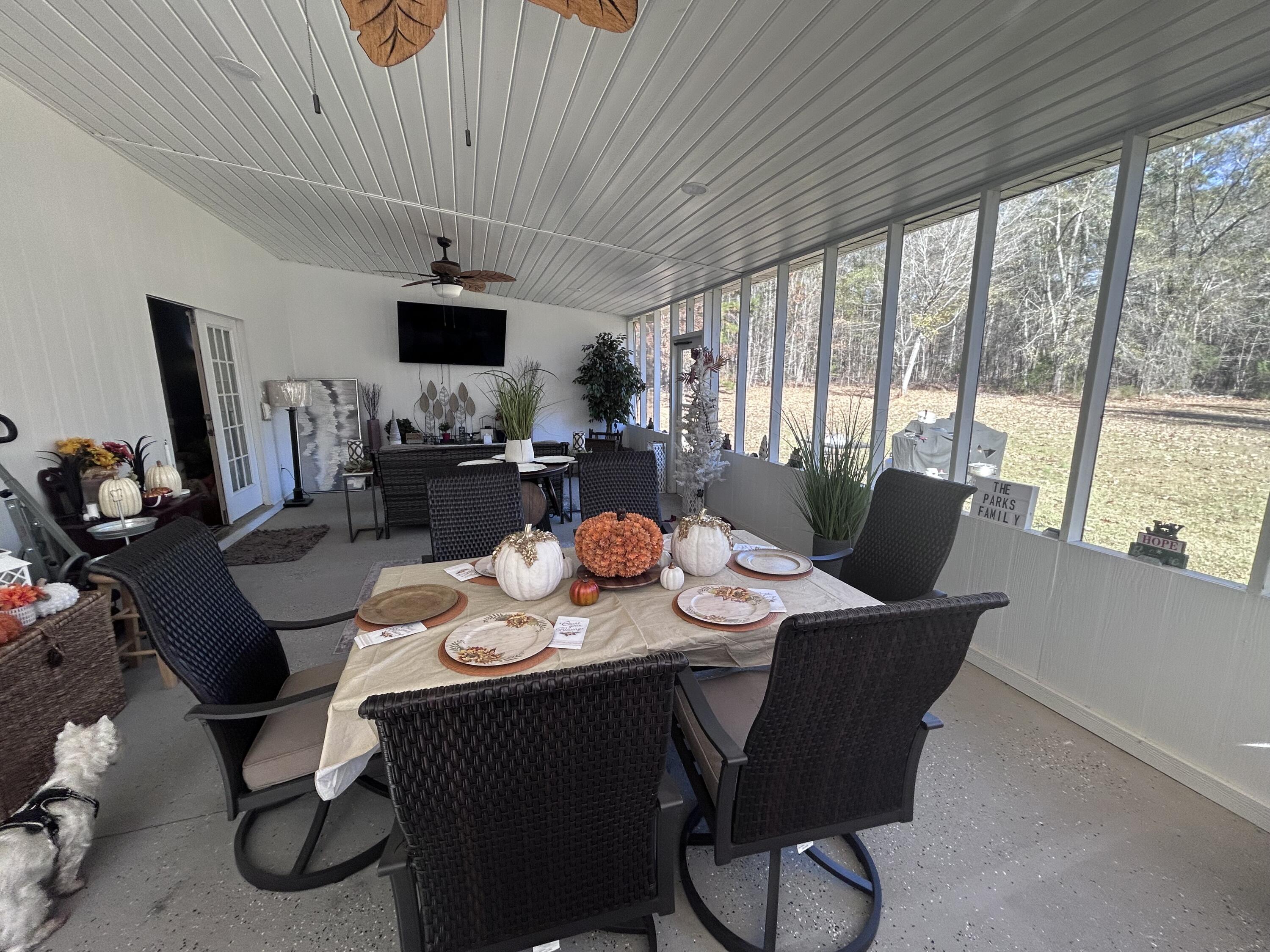 1050 Jones Martin Road Lincolnton, GA 30817 - Photo 28 of 39 Screen Porch w/mounted televisions and a bar.