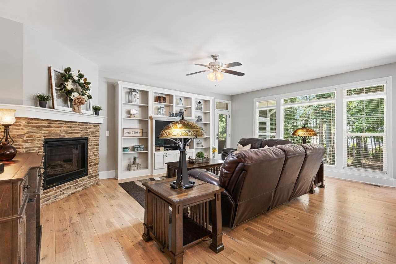 Beautiful stone hearth and built-ins. Note the picture window overlooking the wooded backyard. Great room