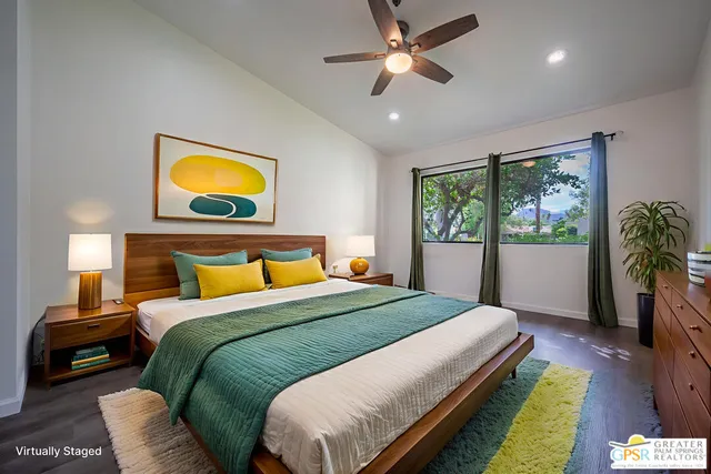 an empty room with wooden floor chandelier fan and windows