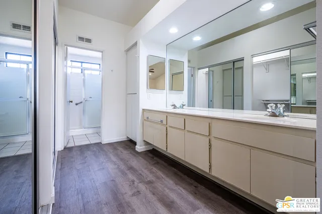 a bathroom with a double vanity sink and mirror