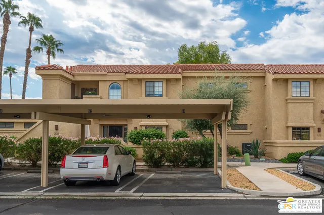 a vase of flowers sitting on a sidewalk