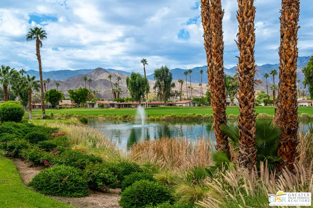 a street sign on a wall next to a road