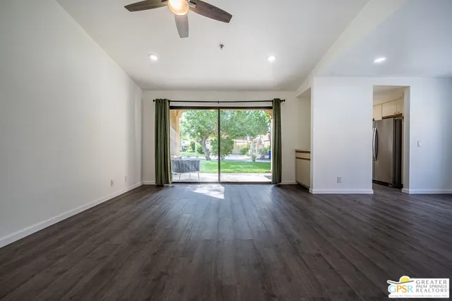 a view of a kitchen with a window and refrigerator