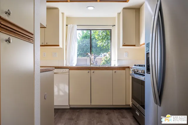 a kitchen with a sink and large window