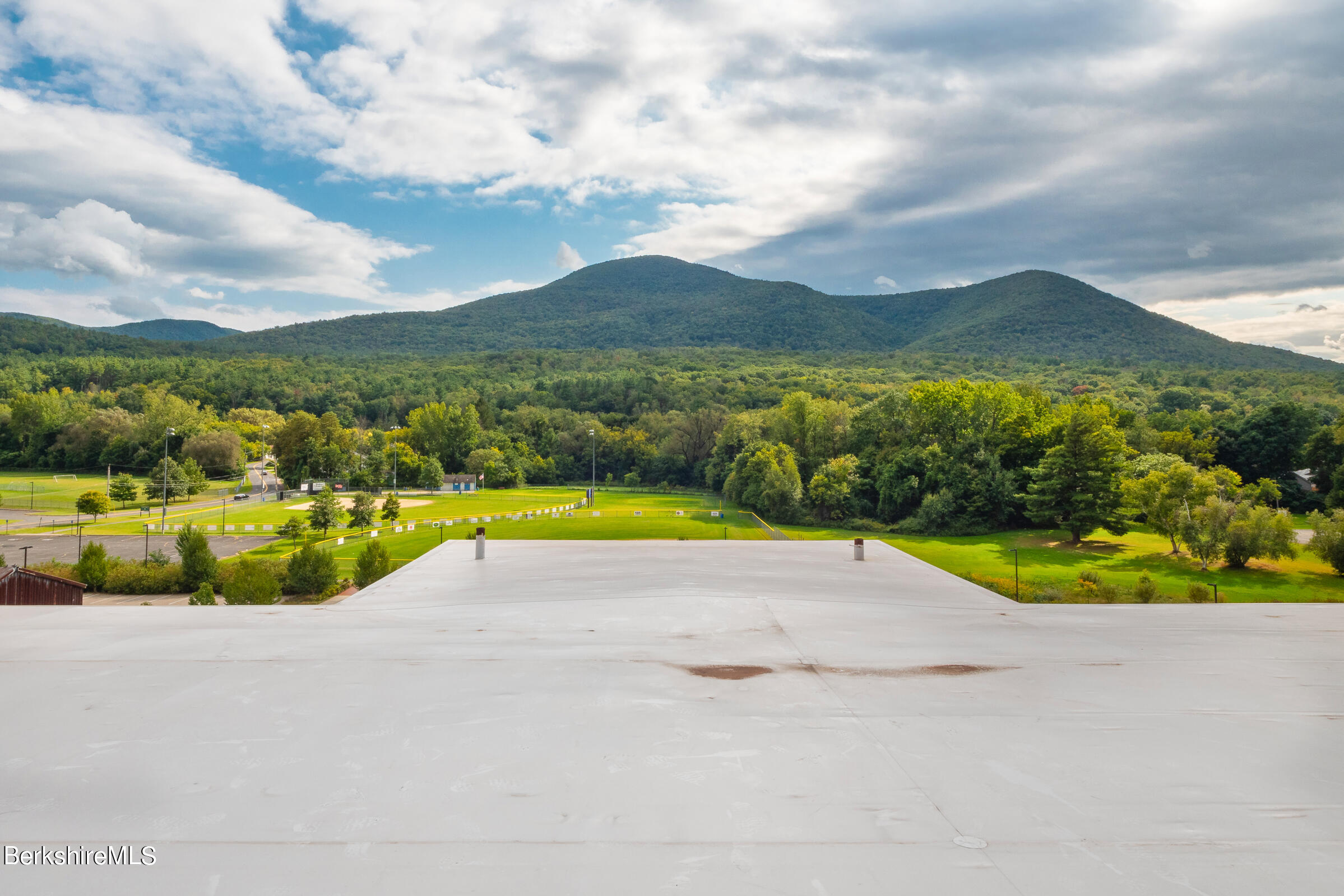 520 State Road, Unit 305 North Adams, MA 01247 - Photo 22 of 27 a view of a terrace with a garden and mountains in the background