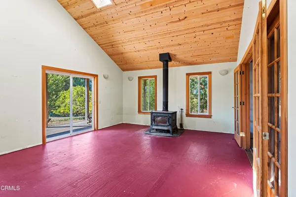 a view of a patio with table and chairs and wooden floor