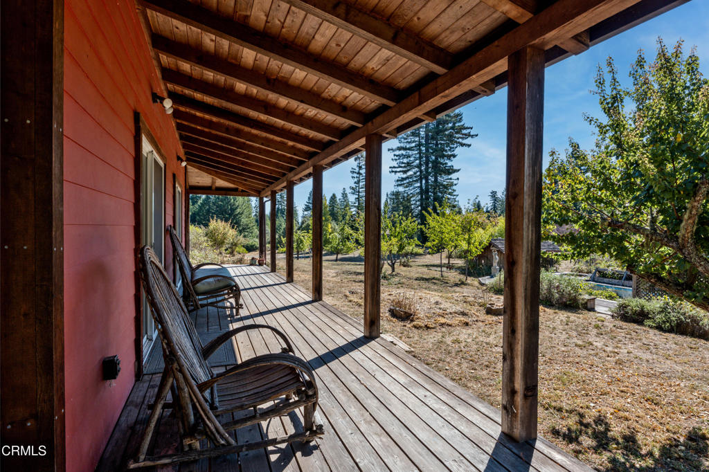 28580 Comptche Ukiah Road Comptche, CA 95427 - Photo 15 of 56 a view of a patio with table and chairs and wooden floor