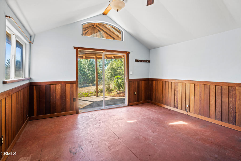 28580 Comptche Ukiah Road Comptche, CA 95427 - Photo 33 of 56 an empty room with a fireplace and windows