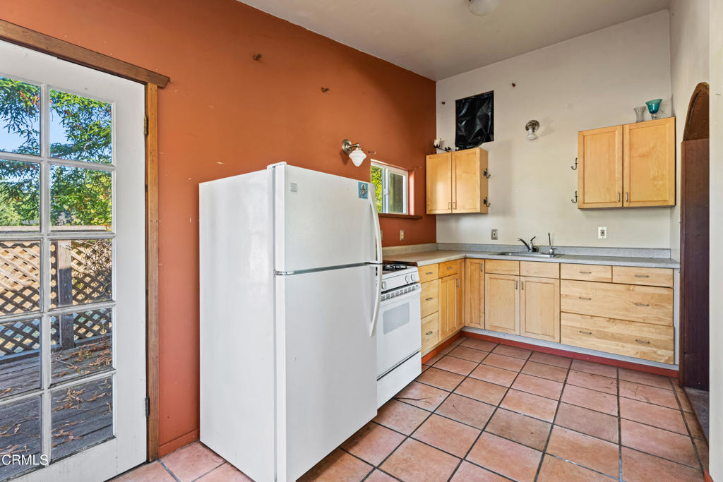 28580 Comptche Ukiah Road Comptche, CA 95427 - Photo 37 of 56 a kitchen with a refrigerator sink and cabinets