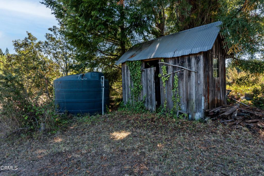 28580 Comptche Ukiah Road Comptche, CA 95427 - Photo 41 of 56 a view of a small house in the forest