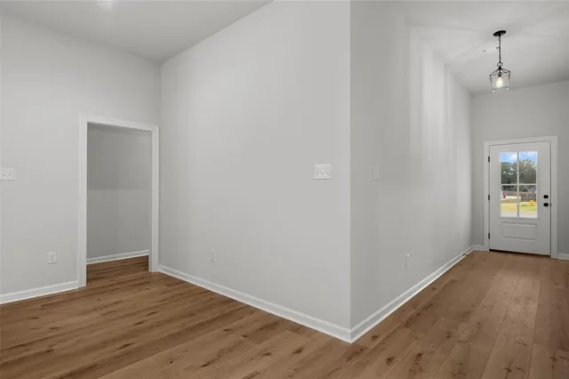 a view of a room with wooden floor