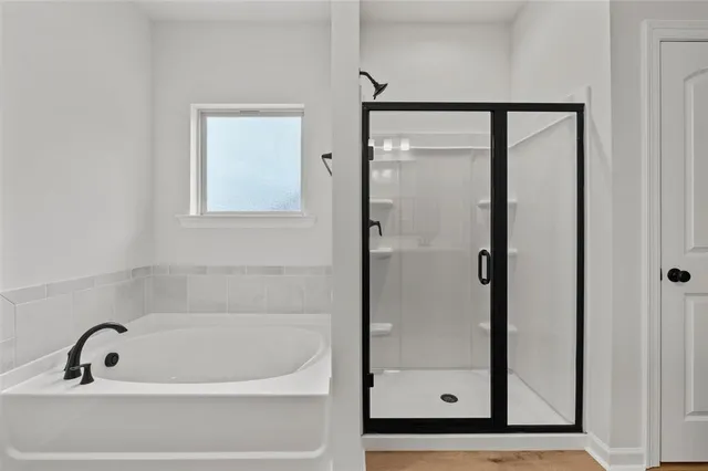 a bathroom with a tub and a shower