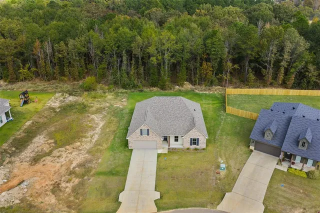 an aerial view of a house with a yard basket ball court and outdoor view