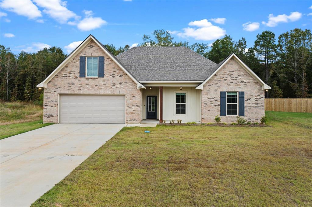1269 BAYOU BAY Court Frierson, LA 71027 - Photo 5 of 30 a front view of a house with a garden and yard
