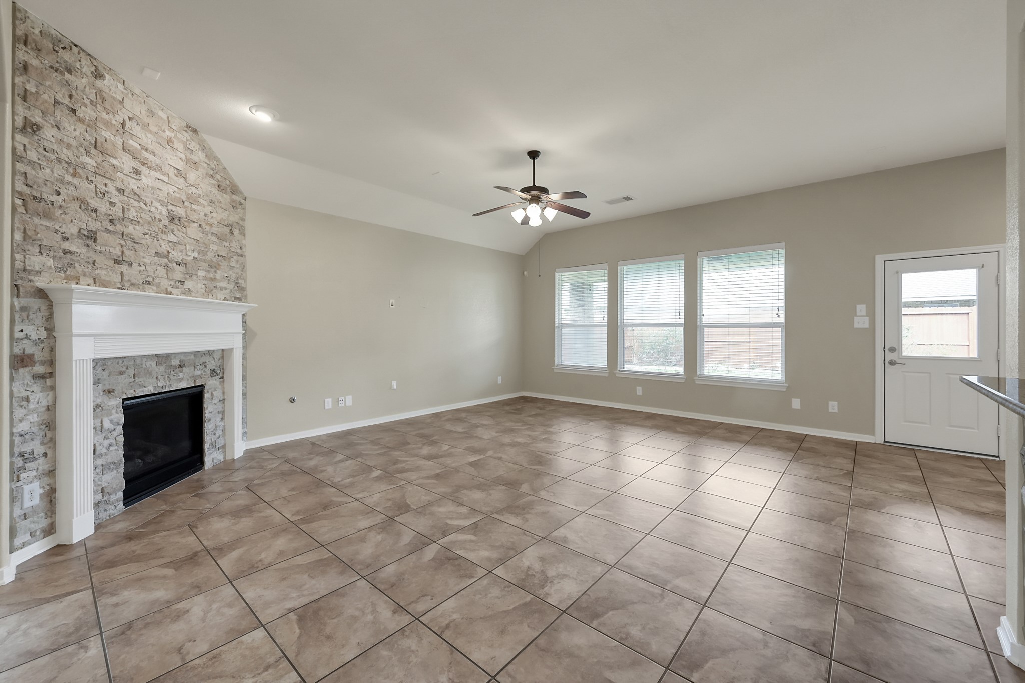 12419 Adams Ridge Lane Humble, TX 77346 - Photo 10 of 46 a view of an empty room with a fireplace