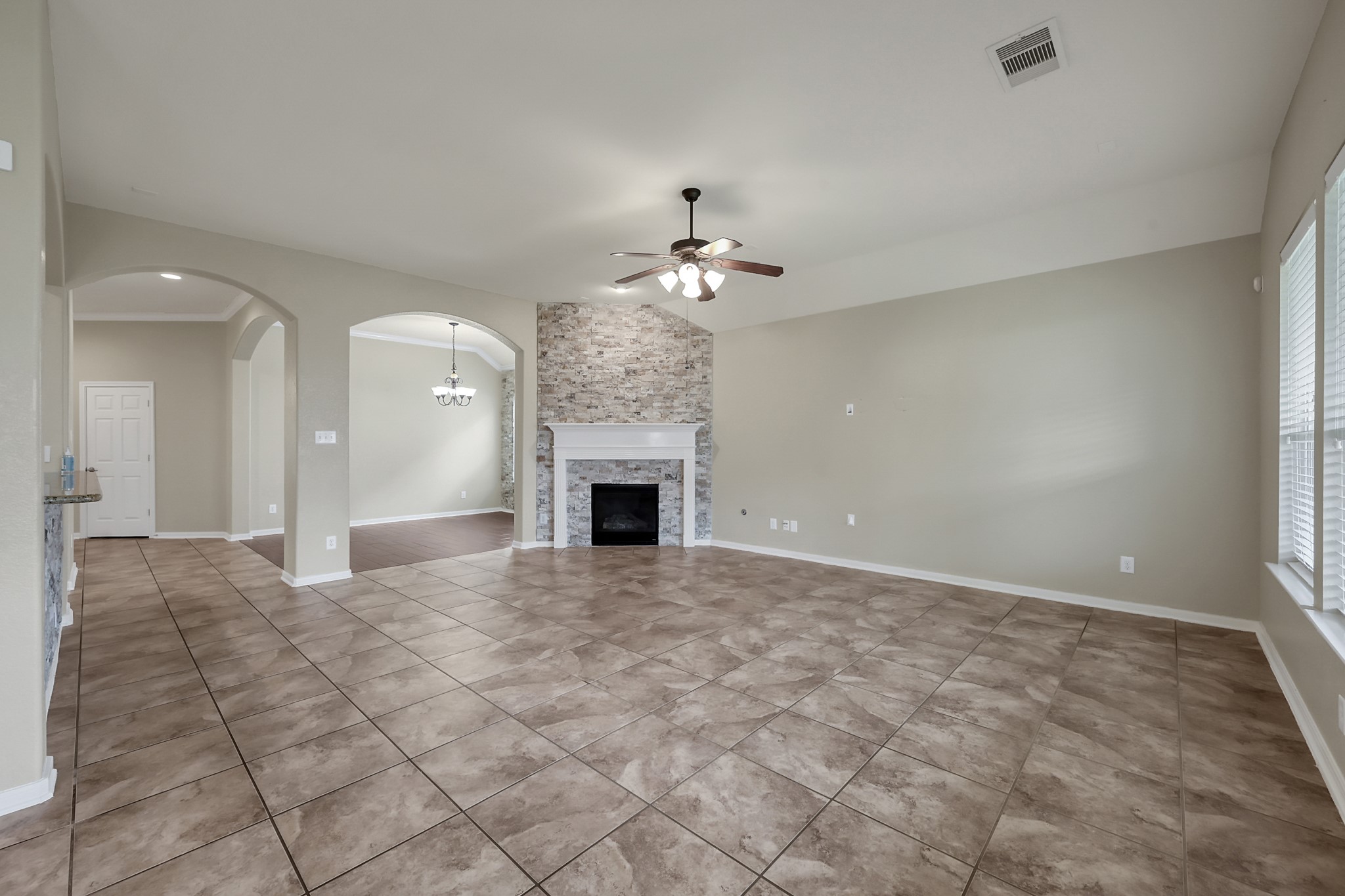 12419 Adams Ridge Lane Humble, TX 77346 - Photo 11 of 46 a view of an empty room with a fireplace