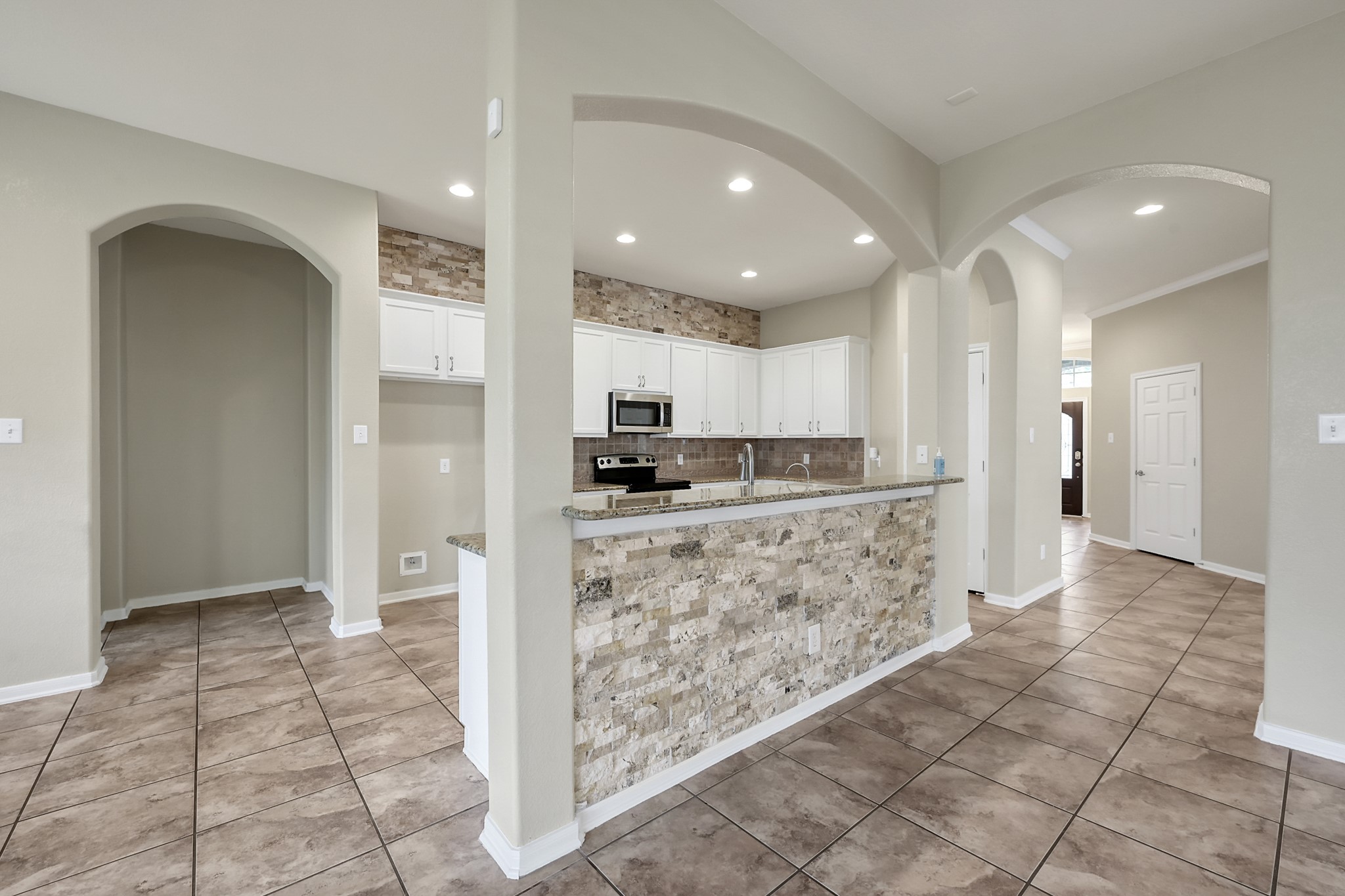 12419 Adams Ridge Lane Humble, TX 77346 - Photo 12 of 46 a view of a kitchen with kitchen island granite countertop a refrigerator and cabinets