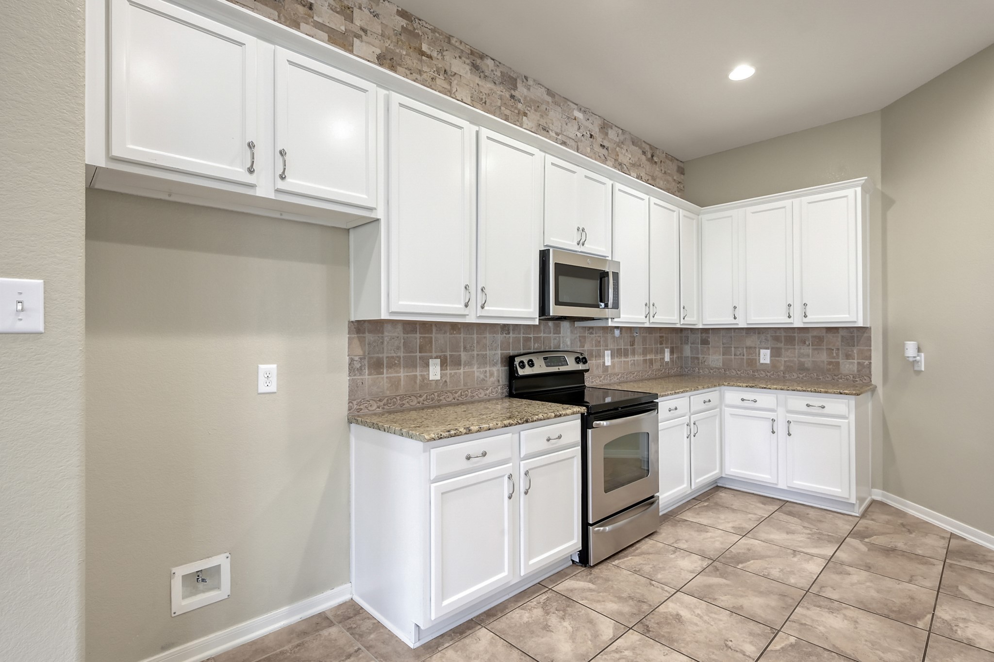12419 Adams Ridge Lane Humble, TX 77346 - Photo 15 of 46 a kitchen with white cabinets appliances and a window