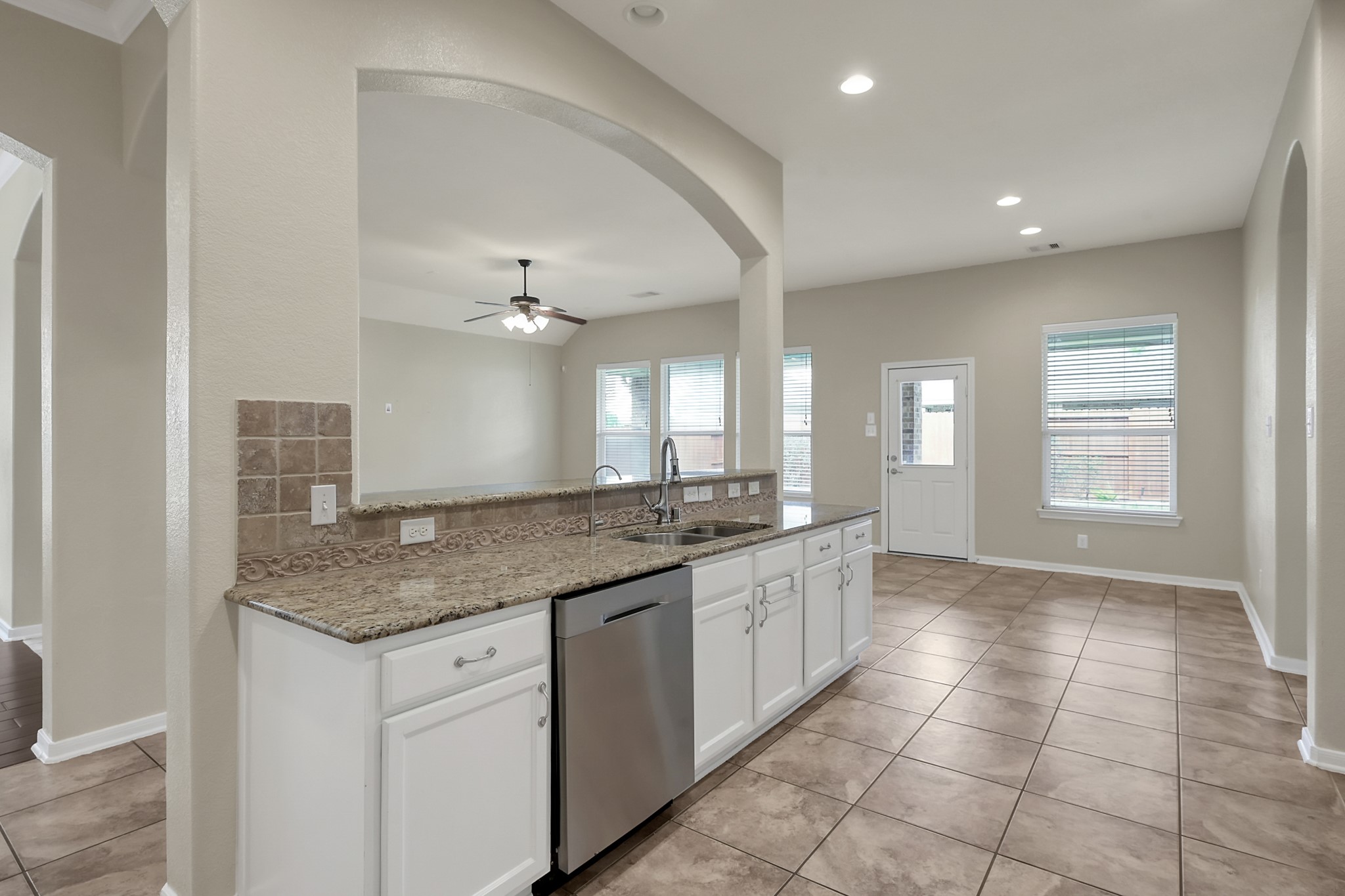 12419 Adams Ridge Lane Humble, TX 77346 - Photo 16 of 46 a bathroom with a granite countertop sink a mirror and a bathtub