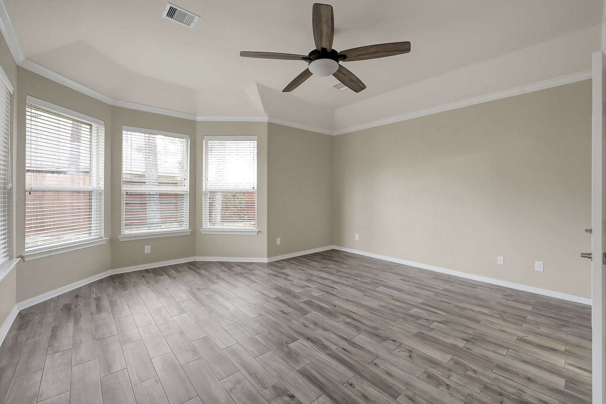 12419 Adams Ridge Lane Humble, TX 77346 - Photo 18 of 46 a view of room with window ceiling fan and hardwood floor
