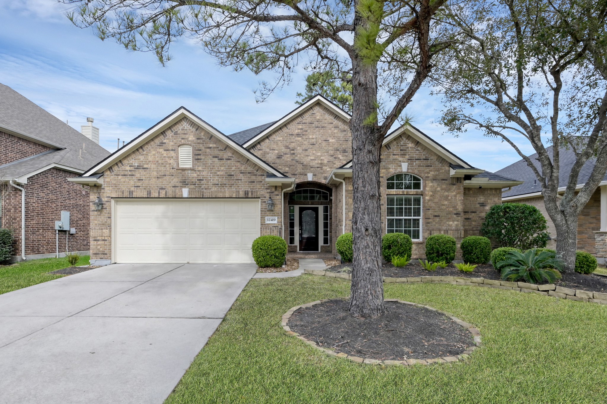 12419 Adams Ridge Lane Humble, TX 77346 - Photo 2 of 46 a front view of a house with garden