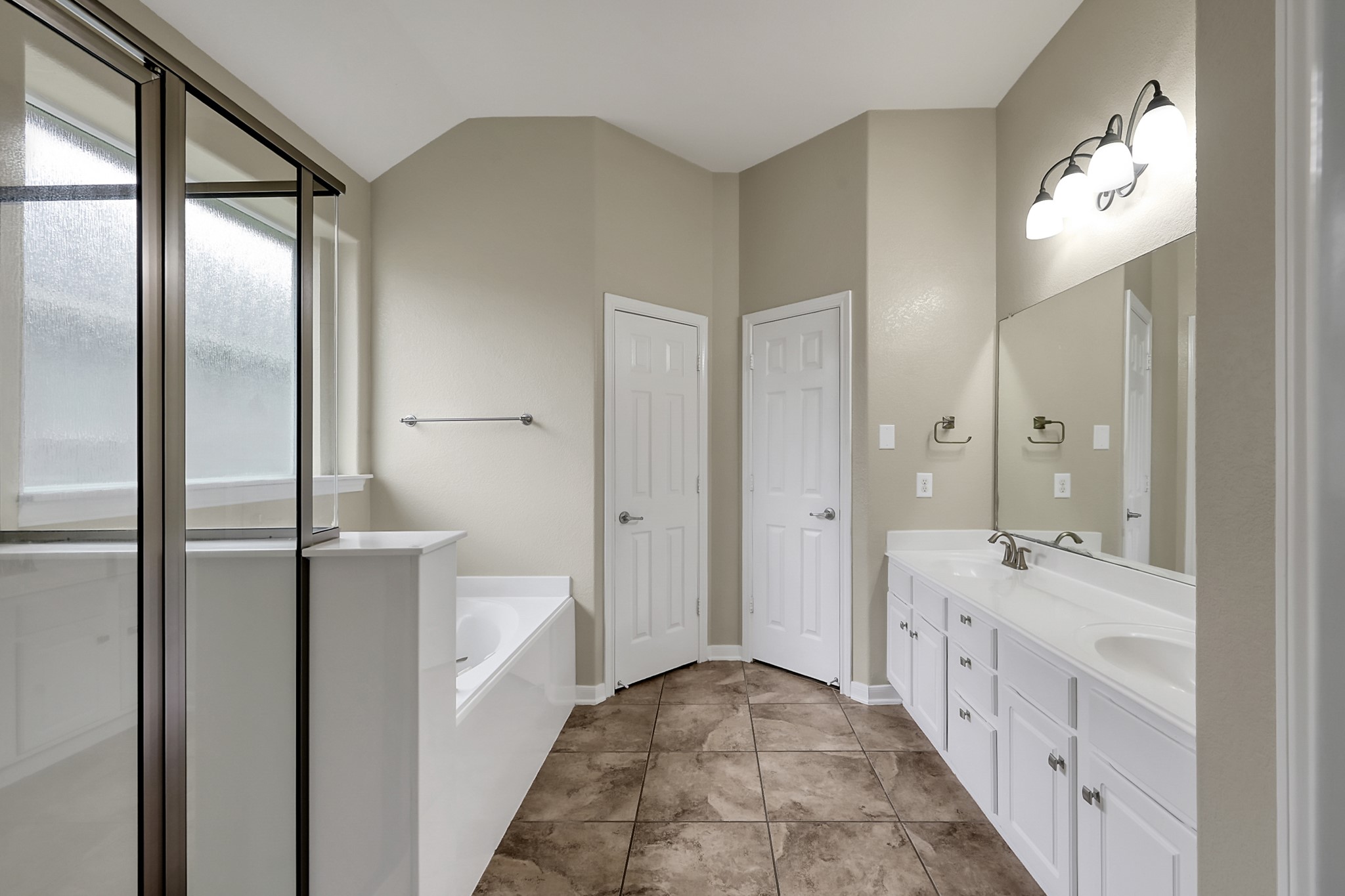 12419 Adams Ridge Lane Humble, TX 77346 - Photo 21 of 46 a bathroom with a double vanity sink mirror and shower