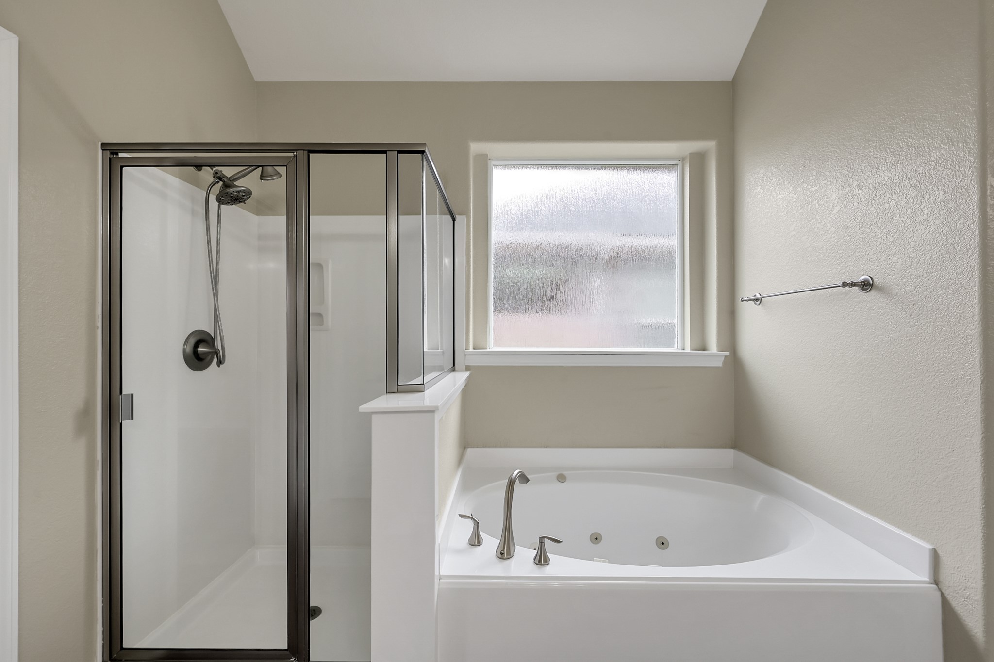 12419 Adams Ridge Lane Humble, TX 77346 - Photo 22 of 46 a bathroom with a bathtub and a window