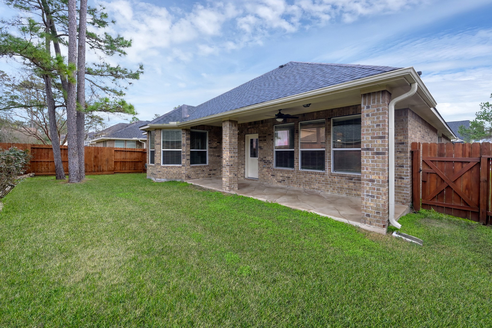 12419 Adams Ridge Lane Humble, TX 77346 - Photo 34 of 46 a view of a house with brick walls and a yard with a large tree
