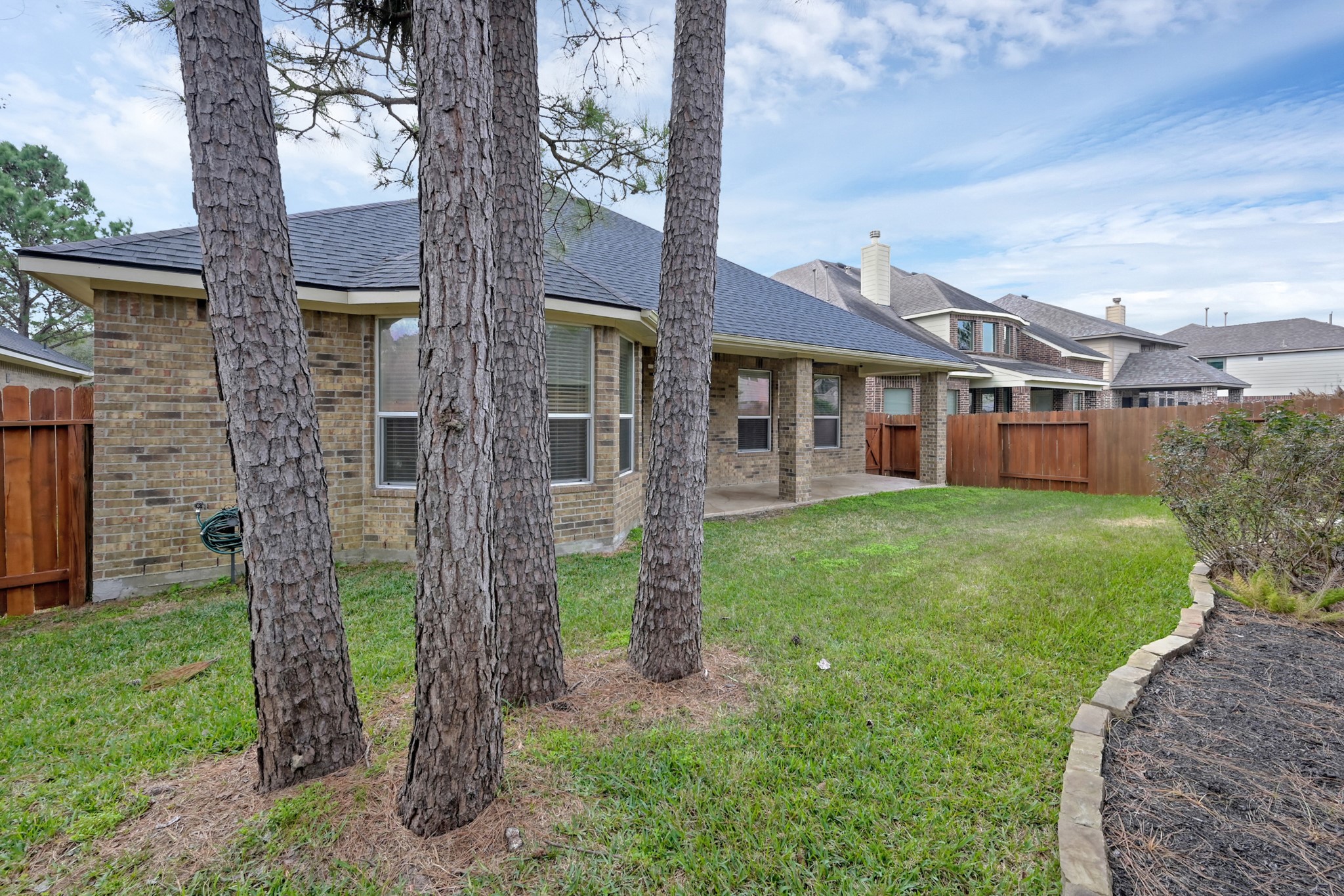 12419 Adams Ridge Lane Humble, TX 77346 - Photo 36 of 46 a front view of a house with a garden