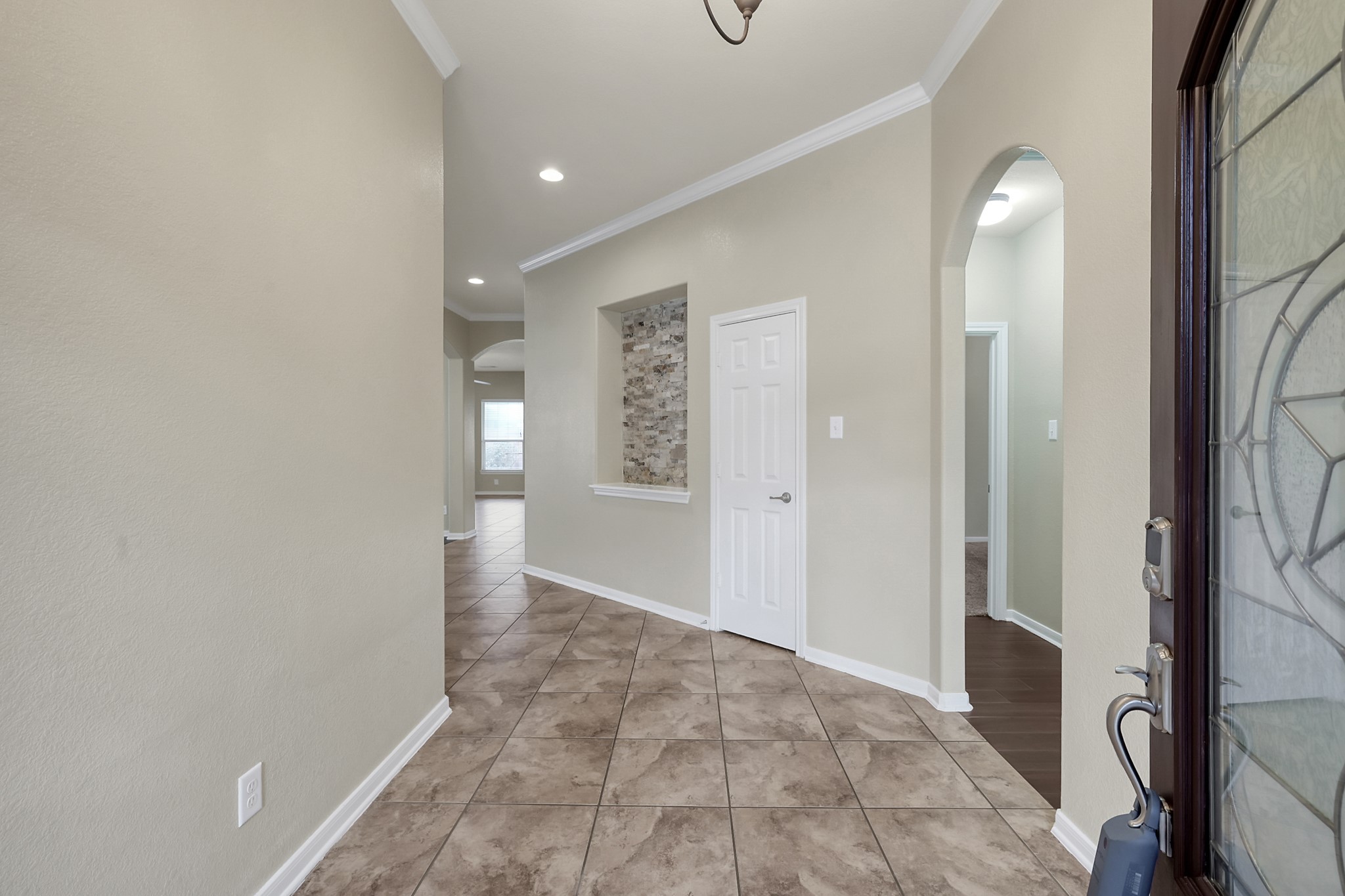 12419 Adams Ridge Lane Humble, TX 77346 - Photo 4 of 46 a view of a hallway with wooden floor and a bathroom