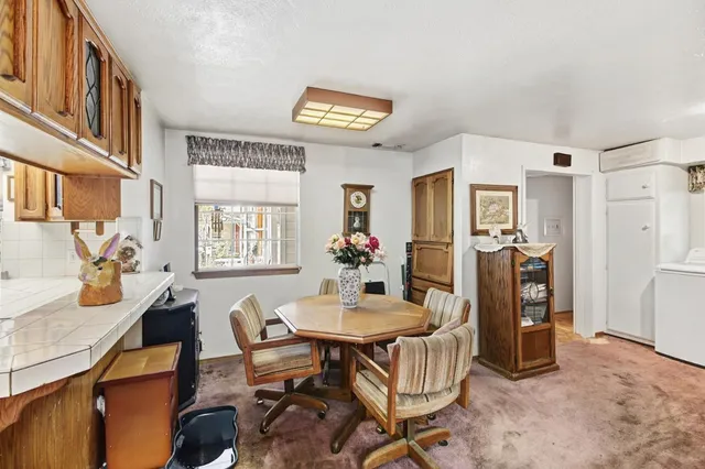 a view of washer and dryer with kitchen in the background