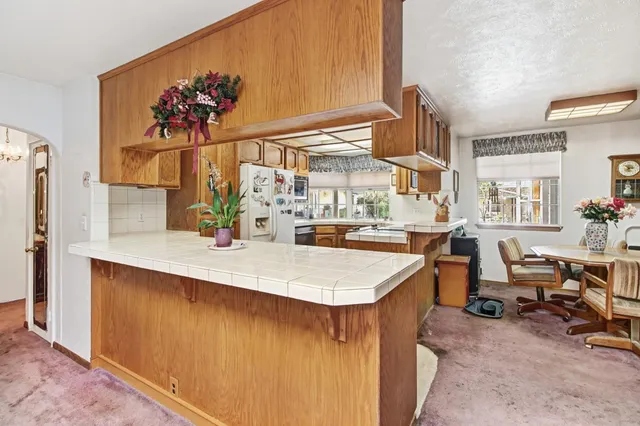 a view of a porch with furniture and backyard